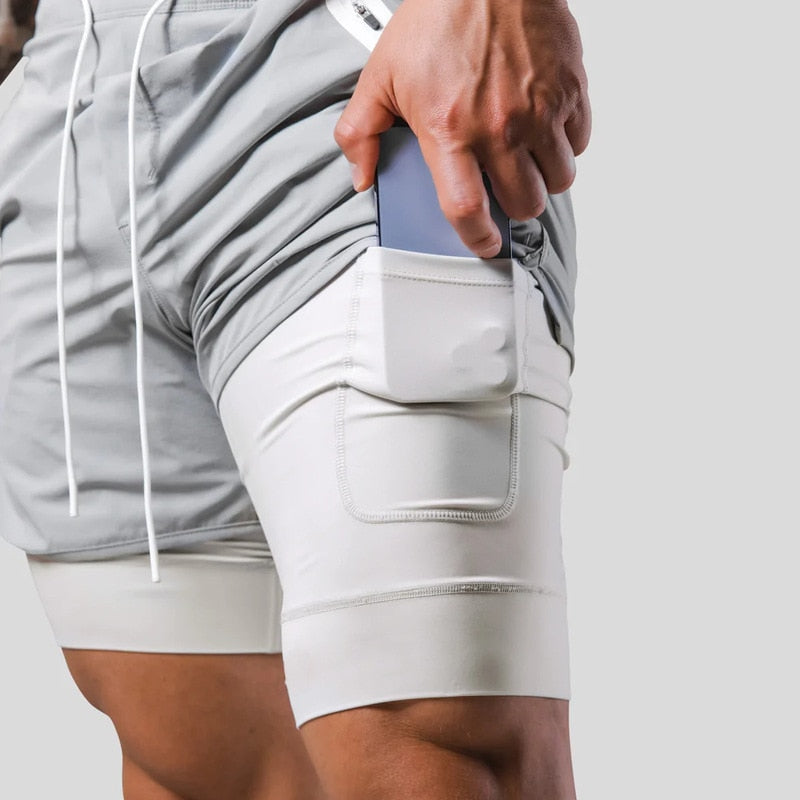 Jaxon – 2 i 1 sportsshorts med lynlåslommer og snøre i taljen